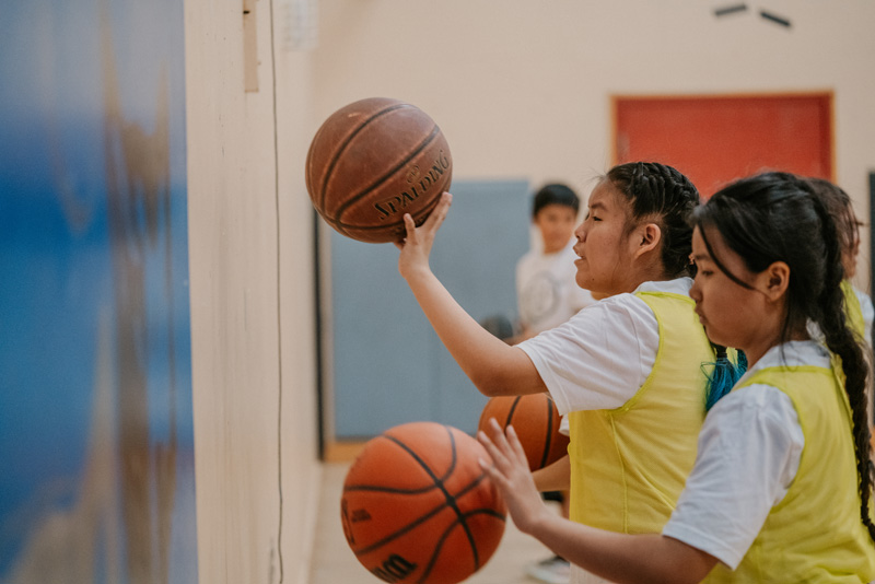 Child aiming to shoot basketball
