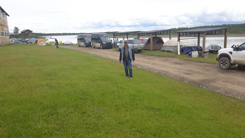 View of trailers and man standing on grass